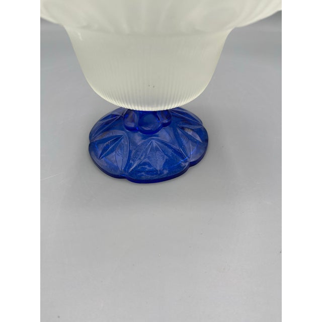 Beautiful vintage frosted glass pedestal bowl featuring an ornate flared rim with raised feather-like detailing and a...