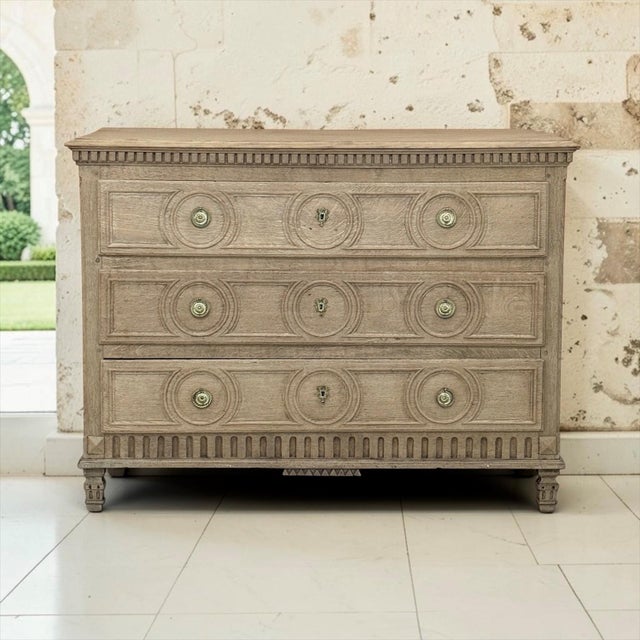 The classical order that defined Louis XVI furniture gives this 18th century oak commode its assured presence. As...
