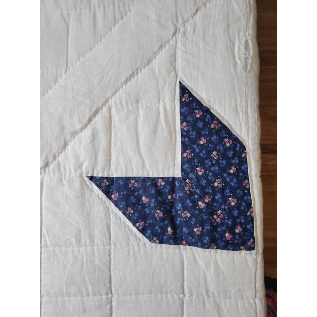 This beautifully handmade quilt features a classic Lone Star pattern, radiating outward in vibrant shades of green, pink,...