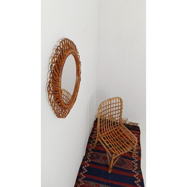 A round mirror handcrafted in Italy between the 1950s and 1960s. The artisans who crafted it bent the thin canes and...