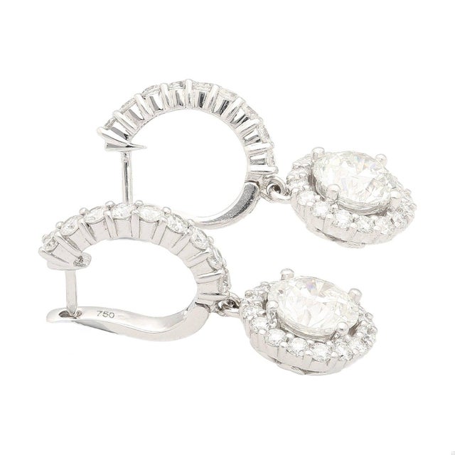18k White Gold Diamond Dangle-Drop Earrings, a luxurious and elegant accessory. Each earring showcases a 1.53-carat GIA-...