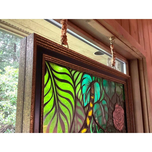 Large striking vintage stained glass featuring a stylized tiger surrounded by lush jungle foliage. Classic '70s palette —...