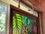 Large striking vintage stained glass featuring a stylized tiger surrounded by lush jungle foliage. Classic '70s palette —...