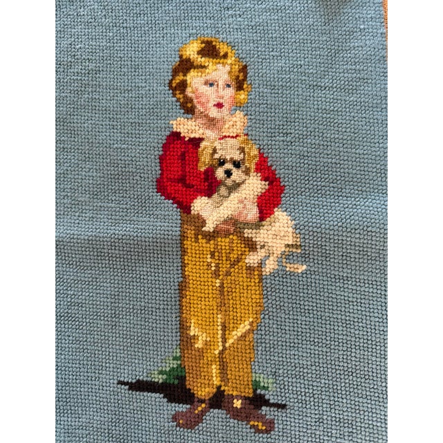 We love finding vintage decor that has history and craftsmanship. This sweet needlepoint textile art features a young...