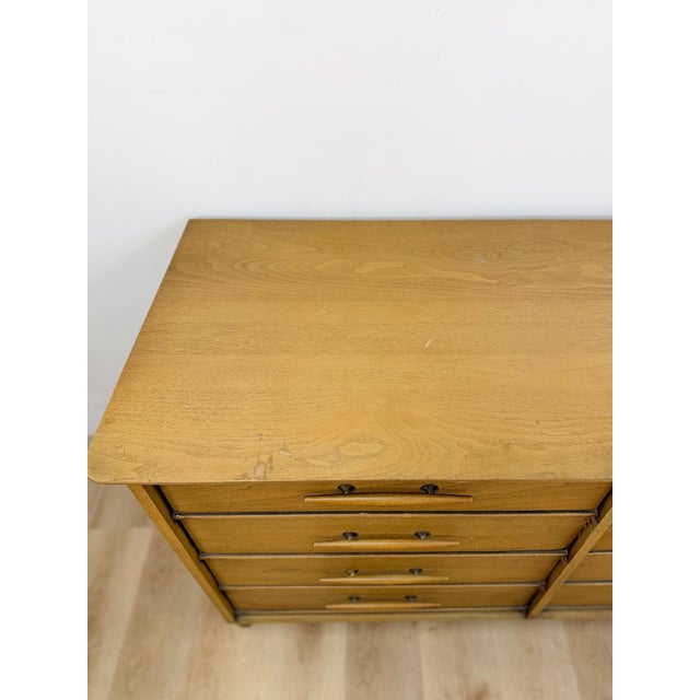 This striking, vintage, Davis Cabinet Company, mid-century modern atomic 8-drawer dresser is a clean and well-crafted...