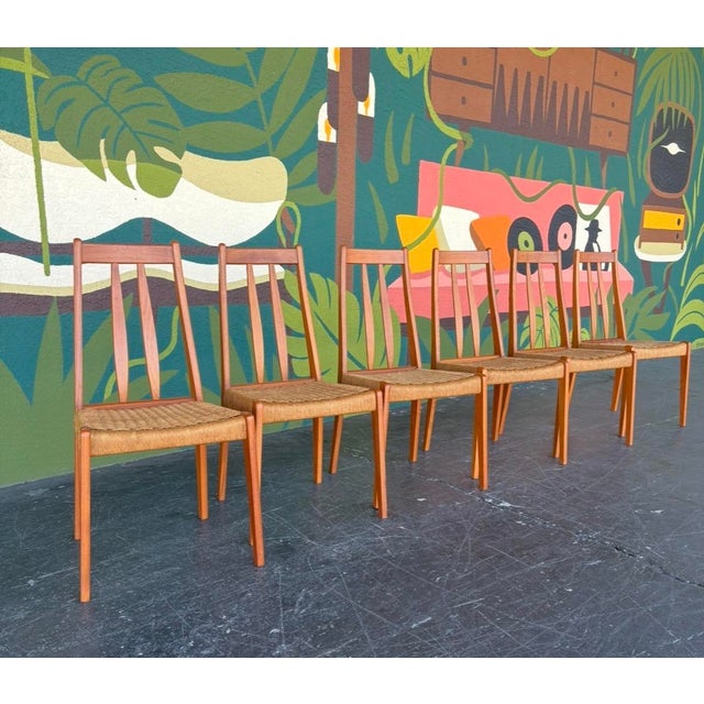 Sleek Danish teak and paper cord dining chairs. A classic set that blends with many styles and stands the test of time