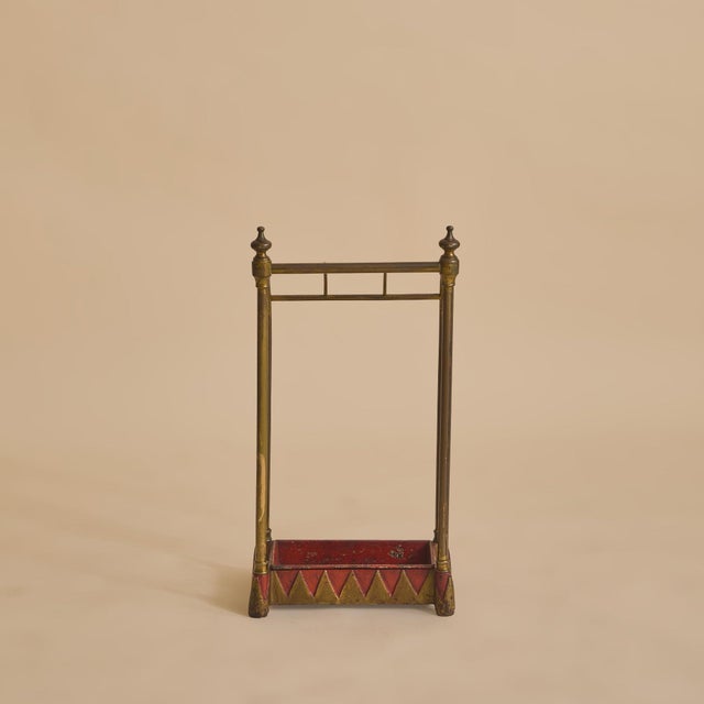 A 19th century English umbrella stand, crafted from warm toned brass, softened by time. The upright frame is formed of...