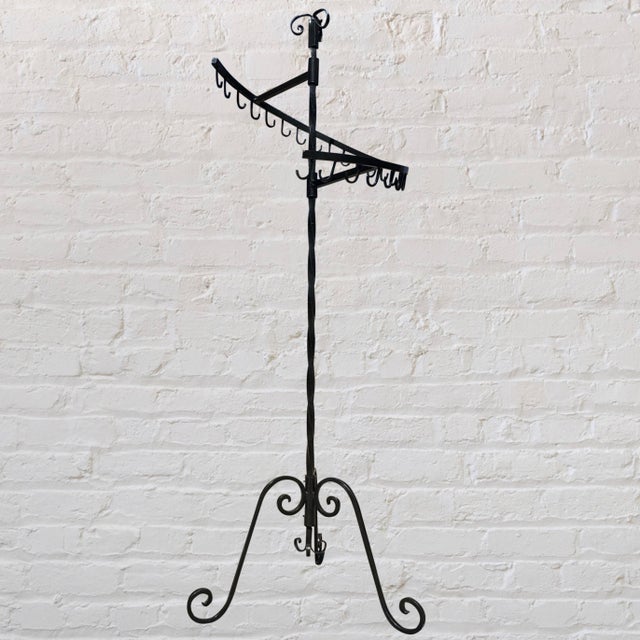 Antique spiral department store clothing display rack. Made of heavy cast iron.