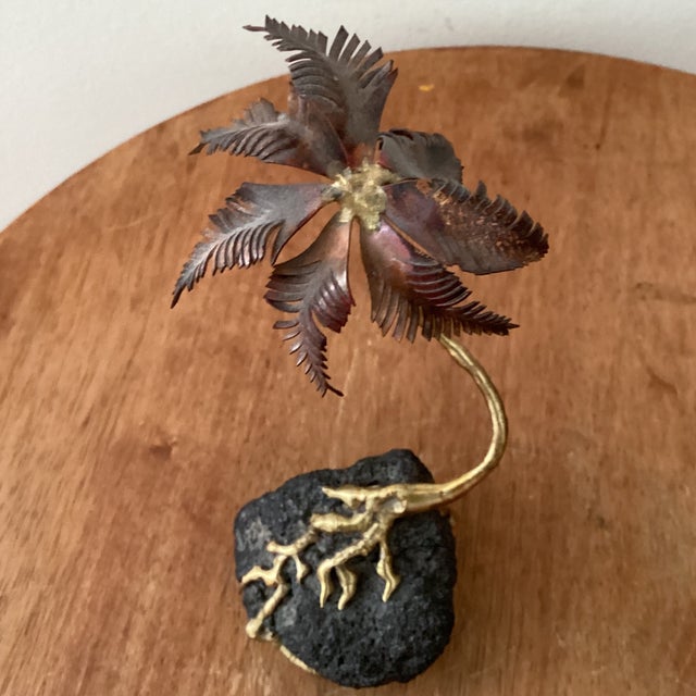 This vintage copper and brass palm tree sculpture is a unique and eye-catching piece that showcases the intricate...