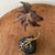 This vintage copper and brass palm tree sculpture is a unique and eye-catching piece that showcases the intricate...