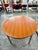 Extendable round table with teak top and legs and satin-finish metal legs, 1960s. Extension system with a sliding central...