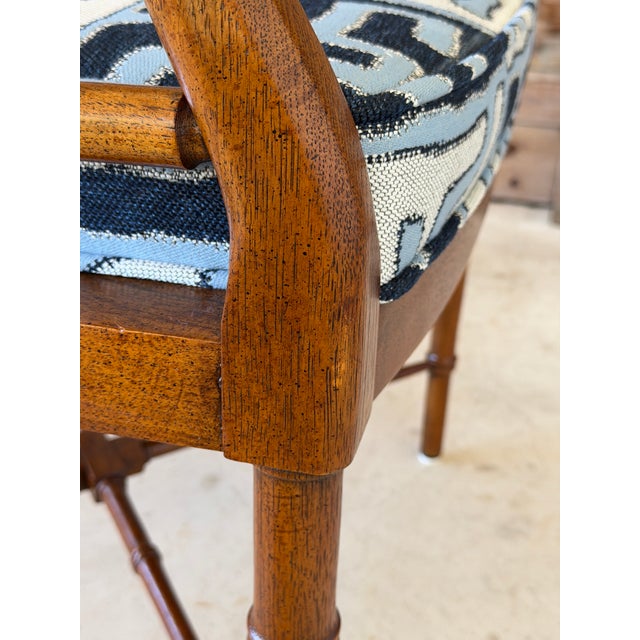 Classic American craftsmanship meets timeless chinoiserie design in this vintage Drexel Heritage faux bamboo armchair....