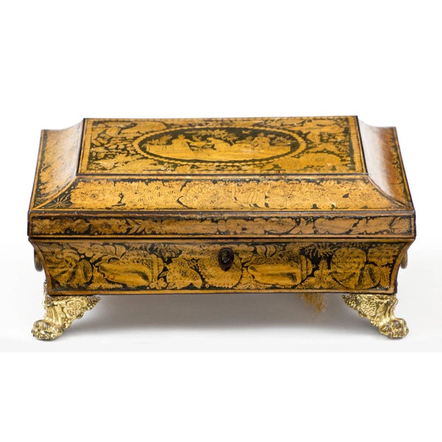 Ornate penwork box of sarcophagus shape decorated with chinoiserie designs all over, the hinged lid with a garden scene...