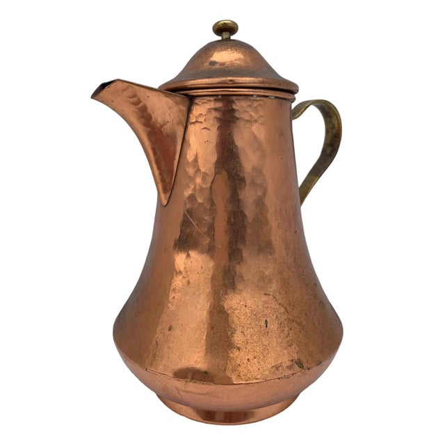 Vintage hand hammered copper tea pot. Features a rustic appearance with slight patina.