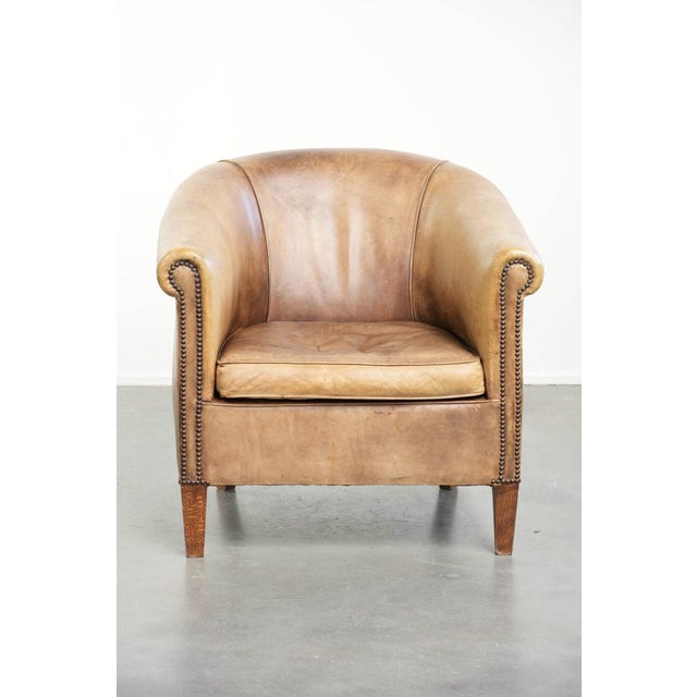This characterful vintage cowhide leather club armchair in English style has a beautiful light colour scheme and features...