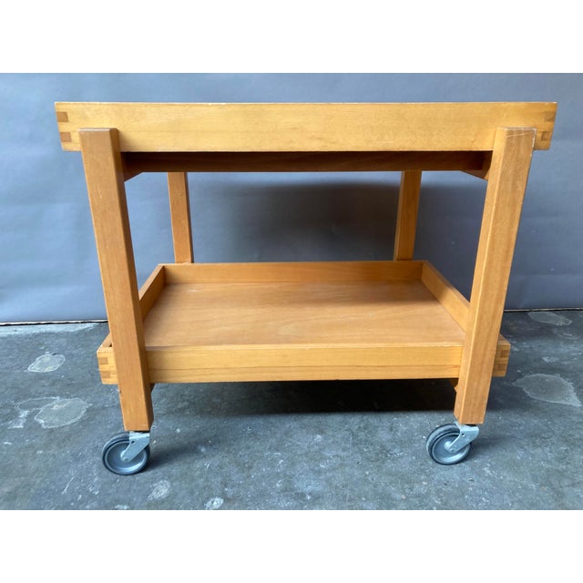 Beech serving trolley ,Hyllinge Møbler/Denmark, with 2 detachable trays and the original wheels. This piece has an...