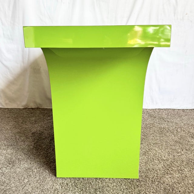 This striking postmodern console table makes a bold, sculptural statement with its vibrant lime green laminate and...
