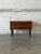 This minimalist lowboy features a compact rectangular silhouette elevated by four square tapered legs. The design...