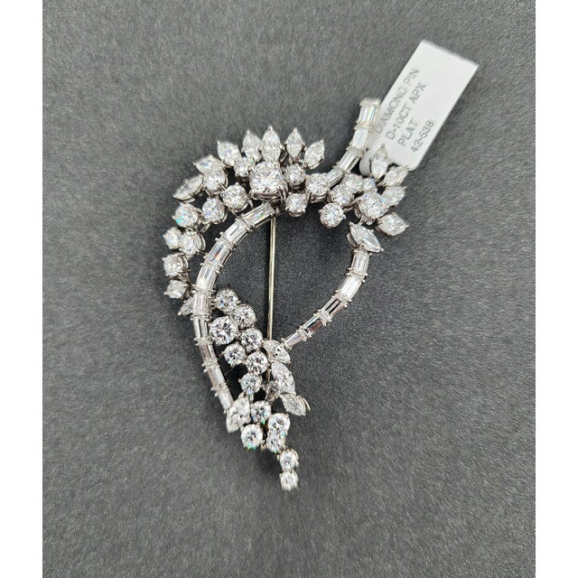This antique brooch features round, marquise, and baguette shape diamonds weighing approximately 10.00 ct. The diamonds...