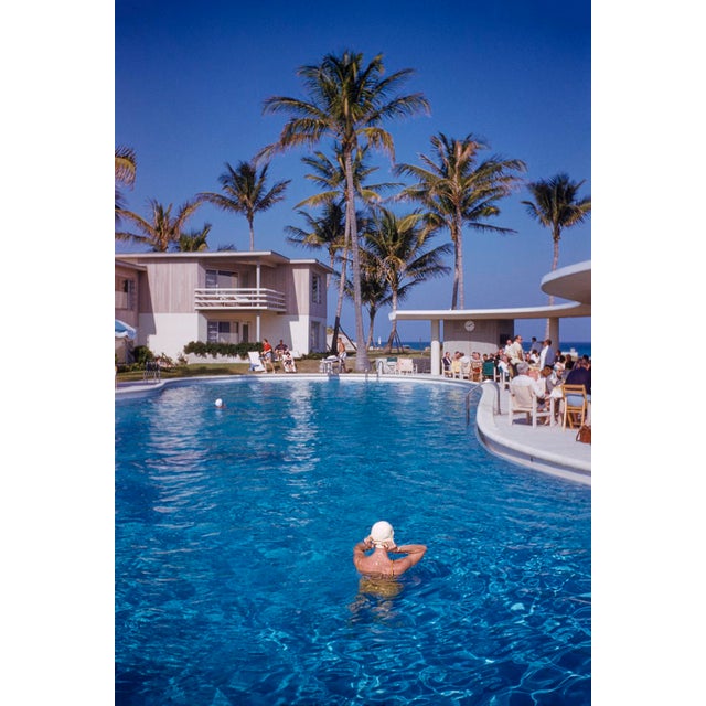 At La Coquille Club by Toni Frissell Mrs Guinness of Palm Springs adjusts her swimming cap in the pool at La Coquille Club...