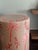 A one-of-a-kind ceramic stool by Made Goods, featuring a tropical palm motif in soft blush and layered reds. This glazed...