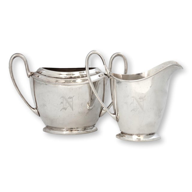 Early 20th century Pairpoint silverplate tea set in a sharply tailored Art Deco form, featuring a coffee pot, sugar bowl,...