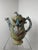 This beautifully ornate, hand-crafted teapot features a sculpted flower on the body of the piece, a sculpted zebra lid,...
