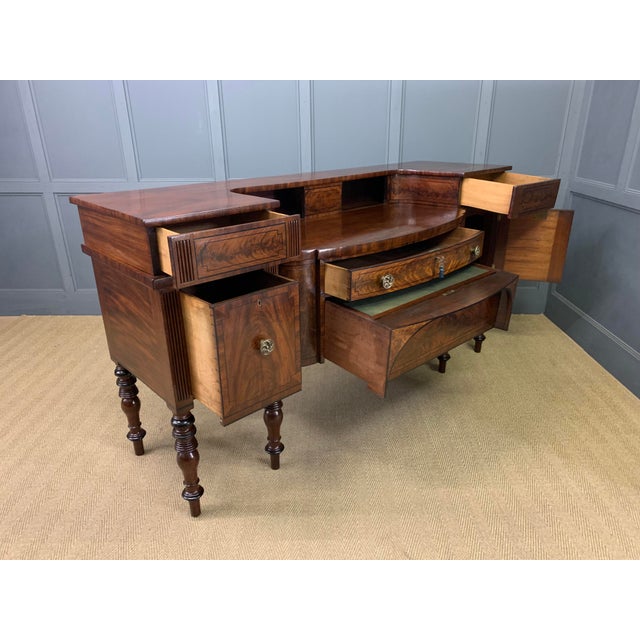 A superb Regency period inlaid flame mahogany sideboard of substantial proportions. Possibly Scottish. Of excellent...