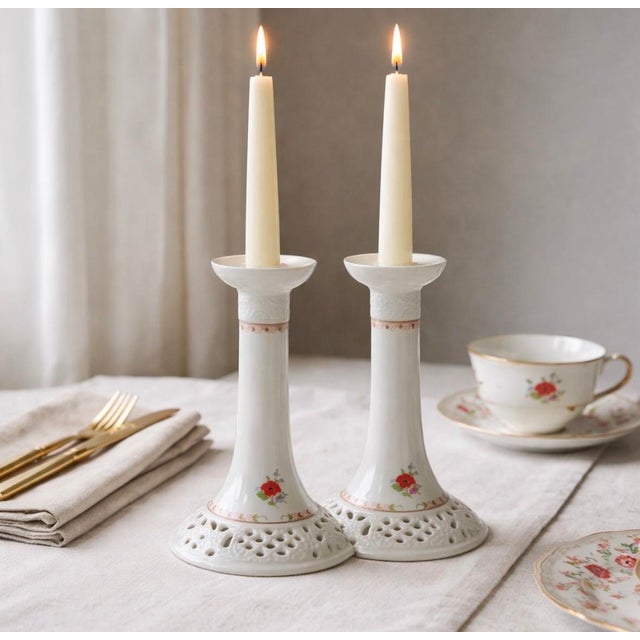 A refined pair of Oscar de la Renta porcelain candlesticks in the delicate Royal Poppy pattern, produced in West Germany....