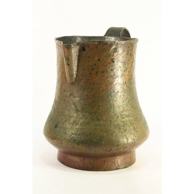 A stunning pouring vessel from Tzarist Russia A jug or pitcher made of tick hammered copper, entirely crafted by hand The...