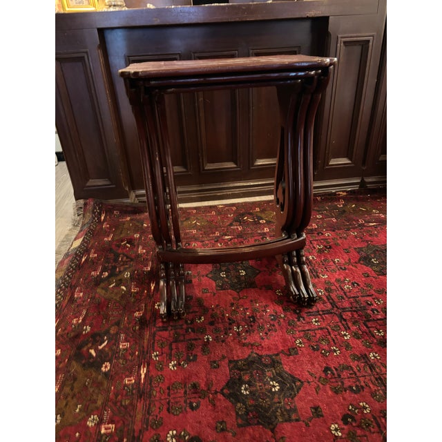 A striking set of three 19th-century Chinese export nesting tables, dating to approximately 1850–1890. Executed in rich...