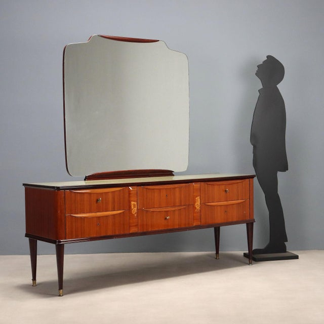 Chest of drawers in exotic wood veneer, with polyester finish, decorative inlay figures, back-treated glass top and brass...