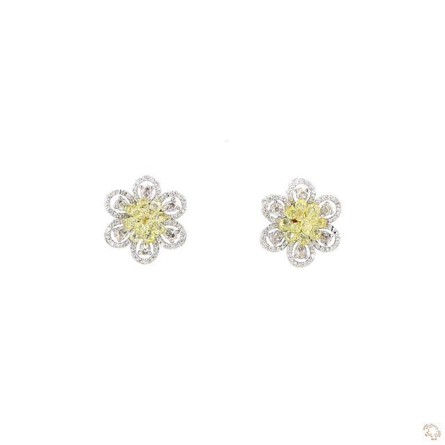 This set of earrings from our contemporary estate collection centers on a 5.38-carat yellow diamond in a faceted briolette...