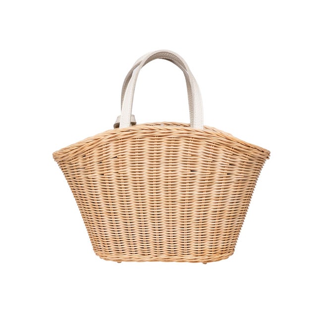 Wicker basket tote with white leather handles and logo tag. Fully lined with inside slip pocket and drawstring closure.