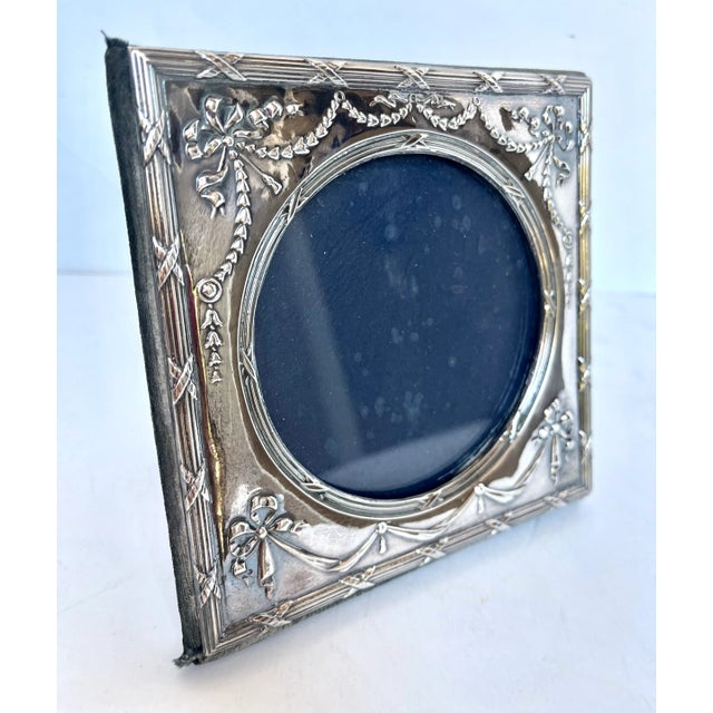 Made in England. Pair of ornate embossed sterling silver picture frames. Square frames with round openings. The regal...
