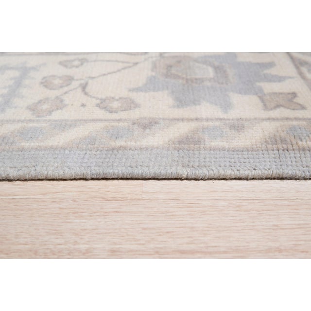 Selene Oushak Rust Hand Knotted Wool Rug, Country of Origin: India. This exquisite piece, though titled “Rust,” presents a...