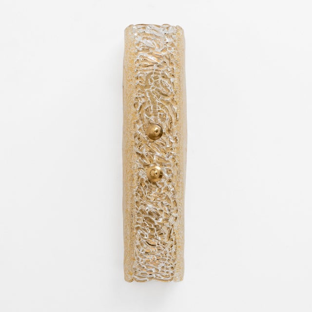 A pair of wall lamps, made in murano, italy, in graniglia murano glass with a submerged gold finish, mounted on a brass...