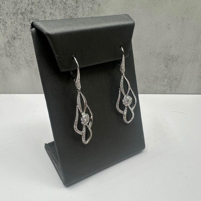 These stunning Diamond Drop Earrings in 18kt white gold feature approximately 1.2ctw of natural GH VS/SI round diamonds,...