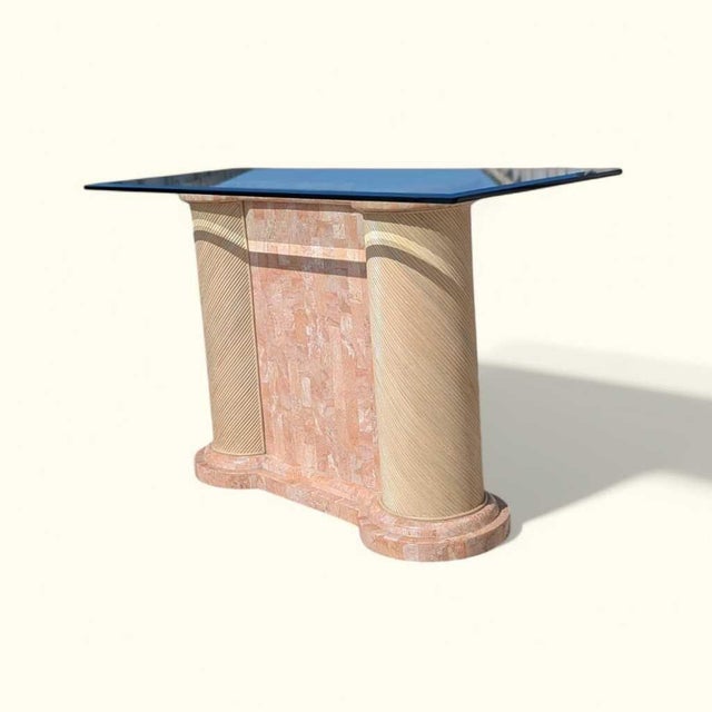 Postmodern console table from the 1980s with a rectangular glass top, tessellated stone base, and rounded textured column...