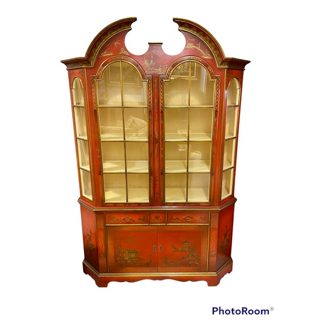 A wonderfully scaled mid-sized display cabinet in red lacquer with Chinoiserie decorations made by the New York City firm...
