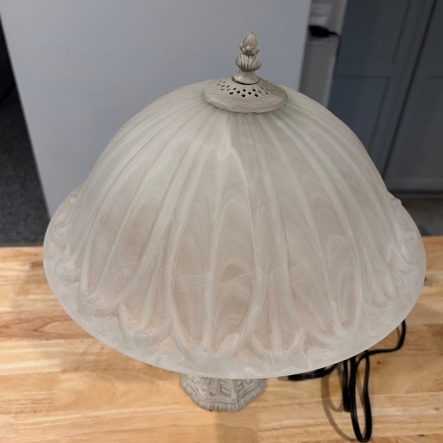 Rare art glass shade and iron stemmed table lamp. Beautiful glow. The glass has a marble design that was made into the...