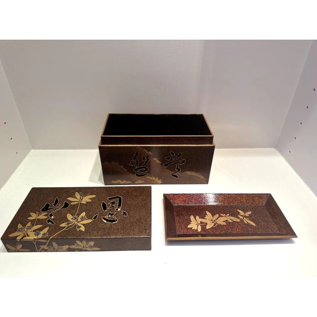 A Japanese lacquer box with lid and an inner tray decorated with Maki-e on a dense nashiji background. The fine box was...