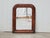 A small French Louis-Philippe style wooden mirror from the early 20th century, with faux tortoise style painted frame and...