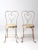 This is a pair of early 20th century painted ice cream parlor chairs. The cream wrought iron metal chairs feature a...