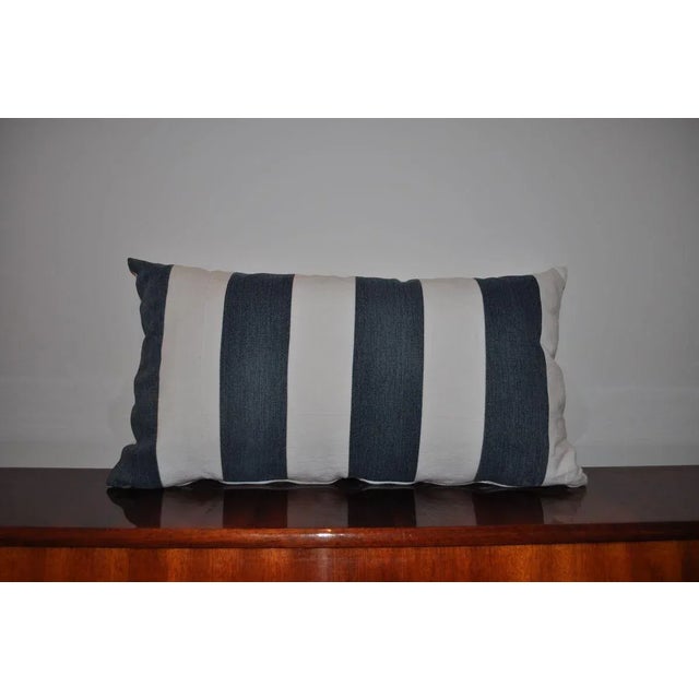 This pillow is a basic home accessory to stripe lovers. The blue and white colored textile pillow looks great and it is...
