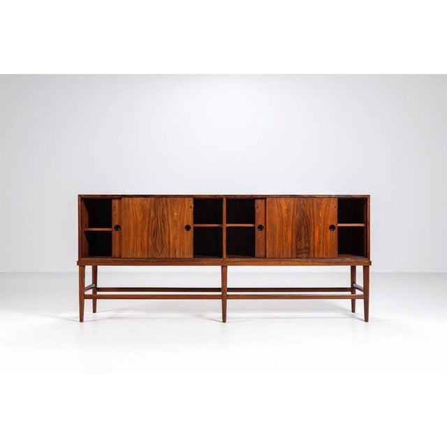 Unusual Danish highboard or sideboard, produced in 1967 and executed in beautifully grained rosewood. The design is...