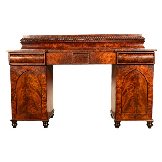 A very elegant antique late Regency flame mahogany twin pedestal sideboard, circa 1825. The sideboard/server with a...