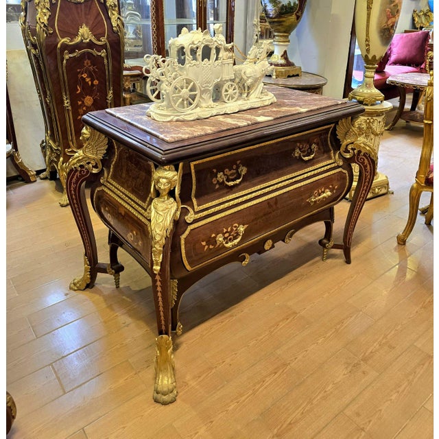 Make a striking statement with this grand French-style commode, an impressive piece that combines rich hardwood...