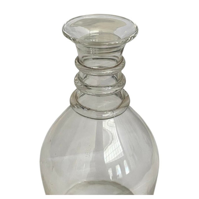 An extraordinary 1950s Steuben three-ring clear crystal wine decanter, crafted in the United States. This elegant vintage...