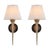 Pair of wall lights dating to the 1950s. Each has a fluted brass cup beneath the bulb holder and a long, tapering pointed...